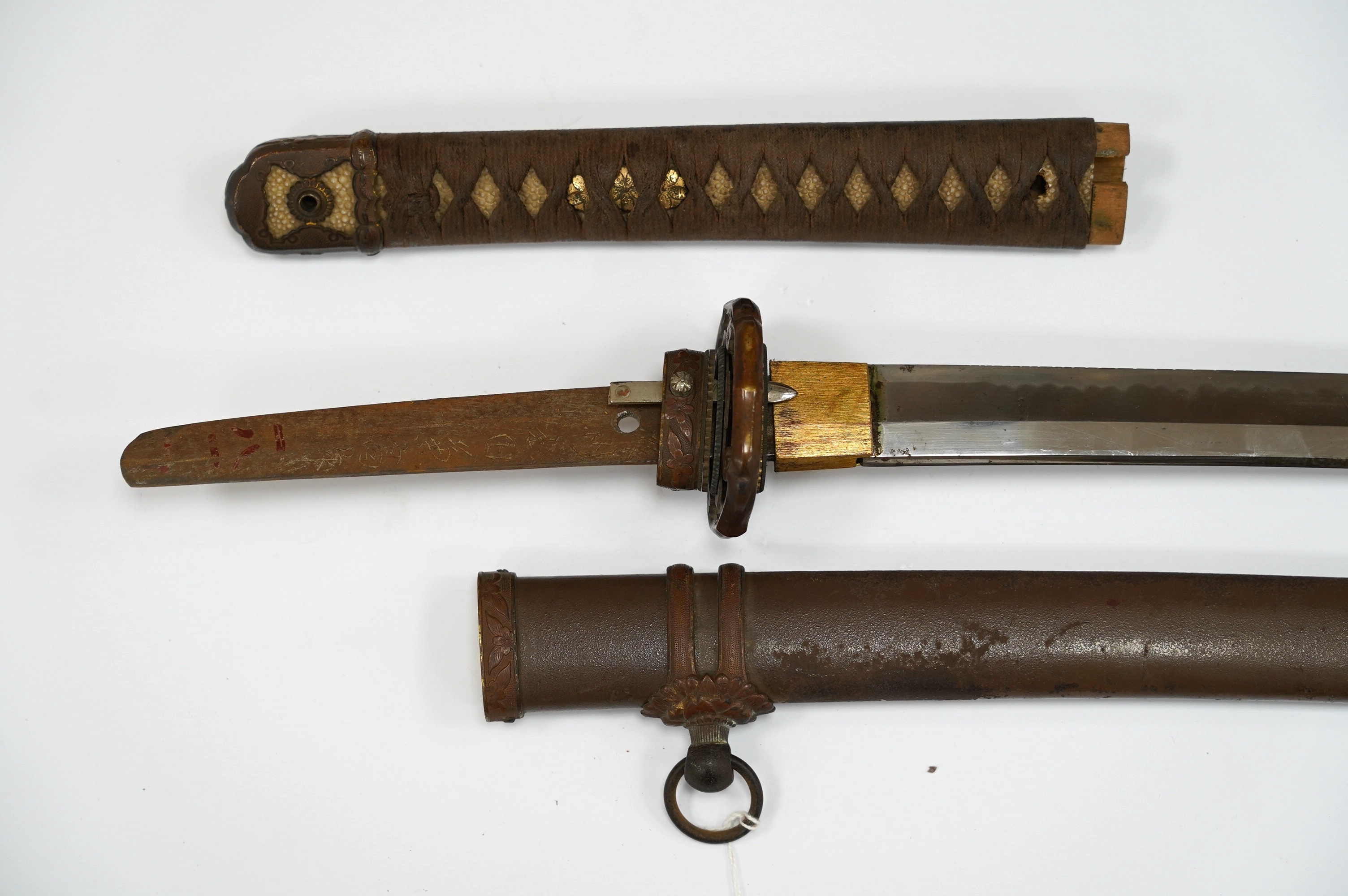 A Japanese WWII army officer’s sword Katana, blade 65cm, signed tang, retaining good polish, in shin gunto mounts. Condition - good